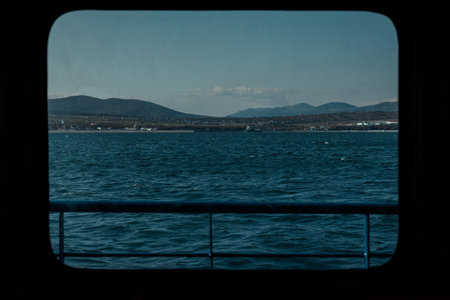 View of the mountains near Gelendzhik through the window of a ship for sea tripsの写真素材