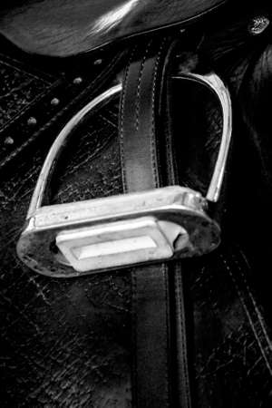 Close up of a saddle on a black leather seat. Black and white photo.の写真素材