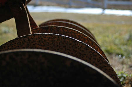 Rusted plow at an abandoned horse farmの写真素材