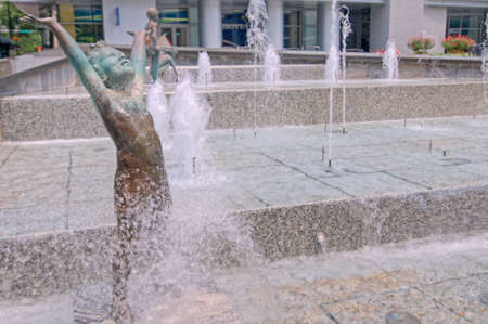 Children playing fountainの写真素材