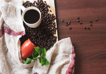 Coffee and Coffee Beans fallen on a table stock photoの写真素材