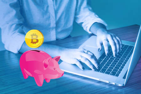 Piggy bank with golden bitcoinの写真素材