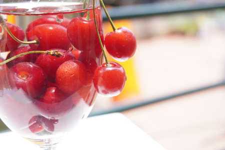 Cherry fruit on a glass with water drops - a beautiful background with organic food.