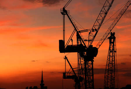 construction crane silhouette on the orange sunset sky background detailの写真素材