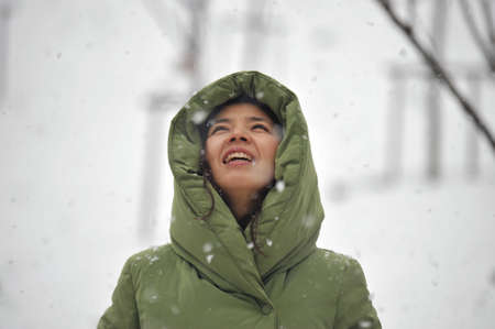 A smiling woman who is looking at snowの写真素材
