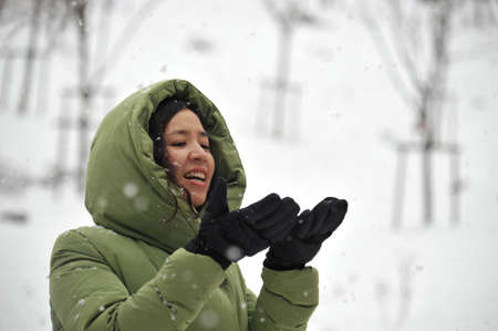 A smiling woman who is looking at snowの写真素材