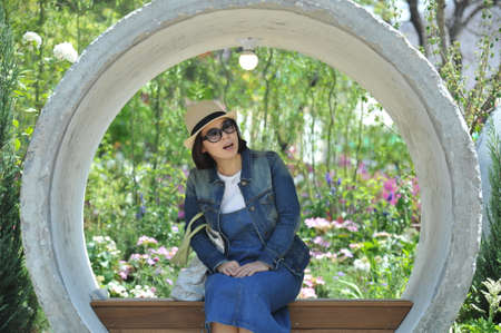 A lady waiting on a bench.の写真素材