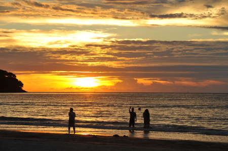 Walking in the sunset on the beachの写真素材
