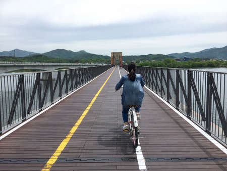 Riding bicycle on the bridgeの写真素材