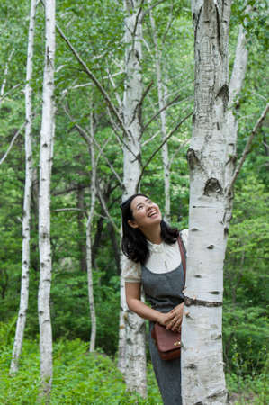 A standing woman the birch forestの写真素材