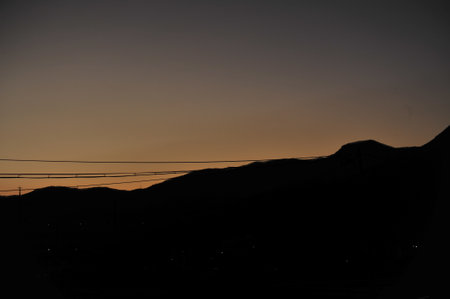 Silhouette of a sunset over the mountains in the evening.の写真素材