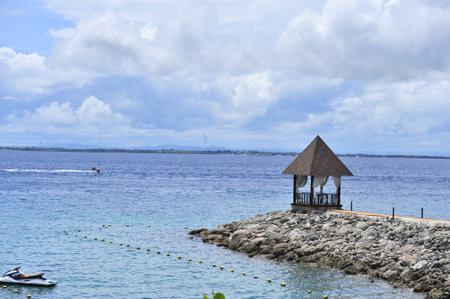 Tropical beach with bungalows and a view of the seaの写真素材