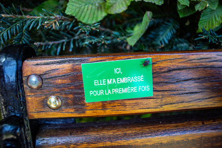 Eco friendly public park sign on a wooden bench in a public park