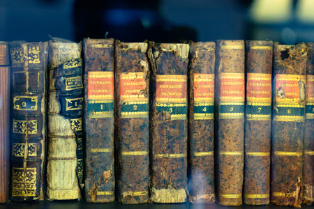 Old books on the shelf in the library. Selective focus.