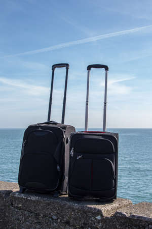 Two suitcases standing on the promenade in DÃºn Laoghaire at the seaside of Dublin Bayの写真素材