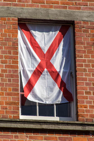 Window in the Rubrics building with a English flagの写真素材