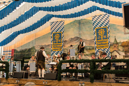 Band making music for the people in the beer tent with traditional bavarian music with brass instrumentsのeditorial素材