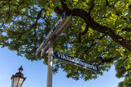 Blue white street sign of Viktualienmarkt at the crossing of Praelat-Miller-Wegの写真素材