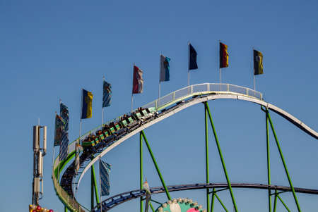 The Alpinabahn rollercoaster at Oktoberfest is a famous fun ride and attracts many peopleのeditorial素材