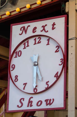 Clock showing the start of the next show at the entrance of an entertainment show