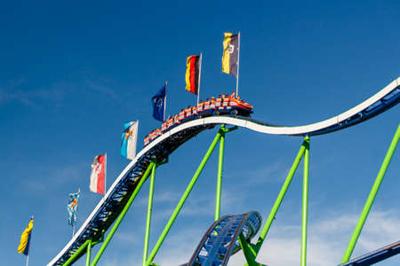 The Alpinabahn rollercoaster at Oktoberfest is a famous fun ride and attracts many peopleのeditorial素材