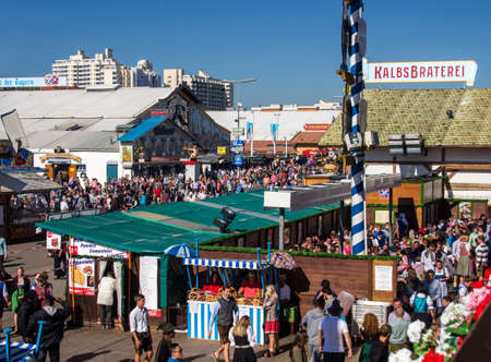 The beer garden of the Braeurosl beer tent with the Hacker Festzelt in the backgroundのeditorial素材