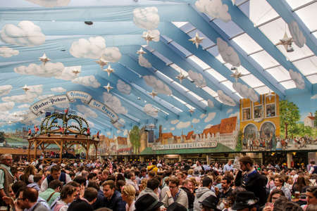 Inside the Hacker Festzelt (Himmel der Bayern) at Oktoberfest with its lovely decoration of the roof and the surrounding wallsのeditorial素材