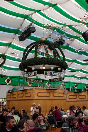 Inside the Armbrustschuetzenzelt with people celebrating Oktoberfestのeditorial素材