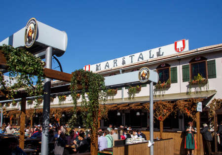 Outside the Marstall beer tent with people celebrating Octoberfest in the beer gardenのeditorial素材