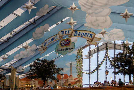 Inside the Hacker Festzelt (Himmel der Bayern) at Oktoberfest with its lovely decoration of the roof and the surrounding wallsのeditorial素材