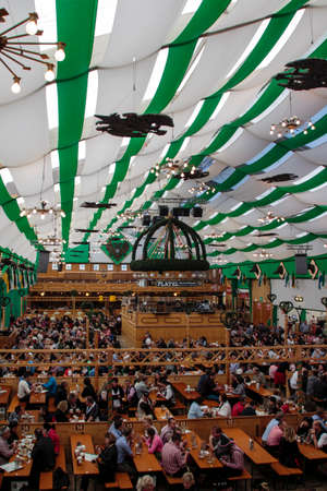 Inside the Armbrustschuetzenzelt with people celebrating Oktoberfestのeditorial素材