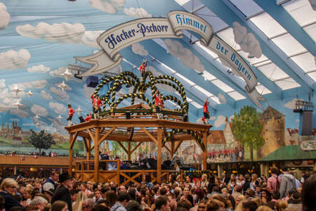 Inside the Hacker Festzelt (Himmel der Bayern) at Oktoberfest with its lovely decoration of the roof and the surrounding wallsのeditorial素材