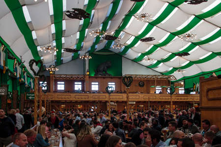 Inside the Armbrustschuetzenzelt with people celebrating Oktoberfestのeditorial素材