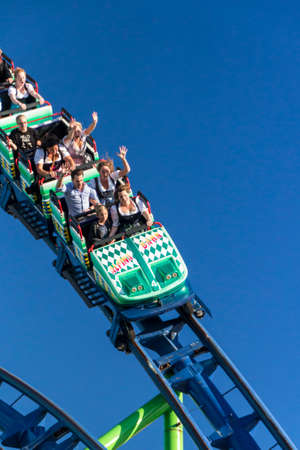 The Alpinabahn rollercoaster at Oktoberfest is a famous fun ride and attracts many peopleのeditorial素材