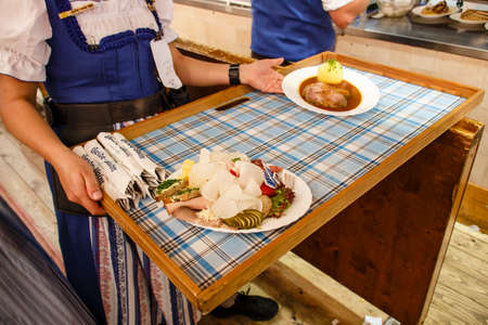 Inside the Braeurosl beer tent at the kitchen area with meals being preparedのeditorial素材