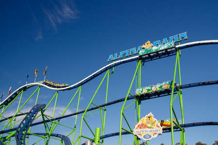 The Alpinabahn rollercoaster at Oktoberfest is a famous fun ride and attracts many peopleのeditorial素材