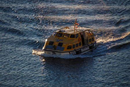Ship's tender boat of AIDA Dive cruise ship in the bay of Bar Harbor