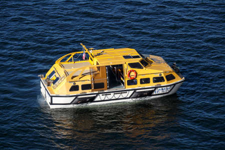 Ship's tender boat of AIDA Dive cruise ship in the bay of Bar Harbor