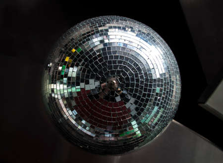 Silver mirror ball hanging down a bar in a discoの写真素材