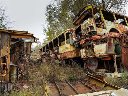 Scrap yard in the Chernobyl Exclusion Zone with old military vehicles and other scrap that was disposed after the nuclear disasterの写真素材