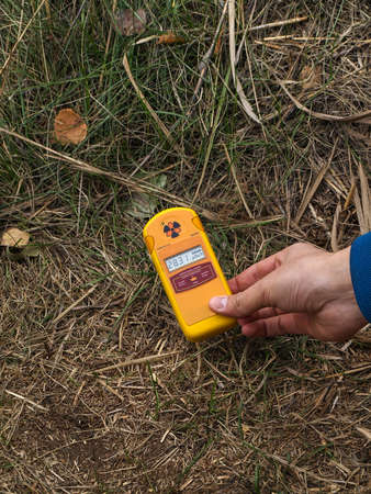 Dosimeter showing higher radiation in front of the Red Forest in the Chernobyl Exclusion Zone which was established after the nuclear disaster in 1986の写真素材