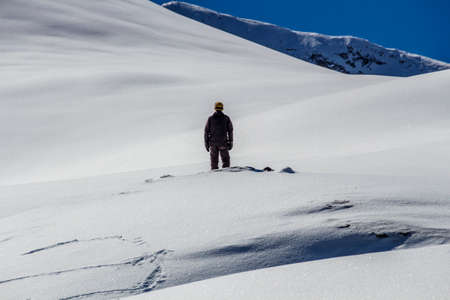 Man looking at the top of the Hintertuxer Glacier (Tuxer Ferner) in Tyrol, Austriaの写真素材