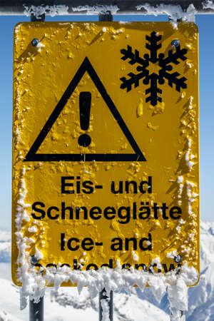 Warning sign indicating ice and packed snow on top of the Hintertuxer Glacier (Tuxer Ferner) in Tyrol, Austriaの写真素材