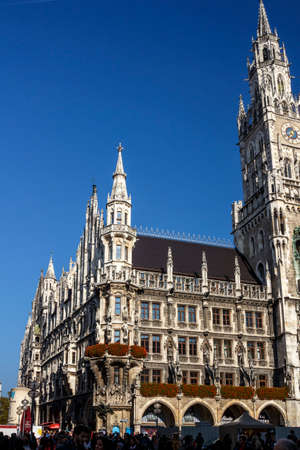 Marienplatz also called Mary's Square with the new city hall is one of the most vital places in Munich and unidentified people are walking alongのeditorial素材