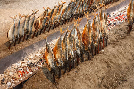 Fireplace of the Fischer Vroni tent on the Theresienwiese during Oktoberfest with it's famous fish on a stickの写真素材