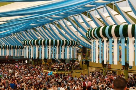 Munich, Germany - September 24, 2016: Inside the Ochsenbraterei beer tent at Oktoberfest with people celebrating and drinking beerのeditorial素材