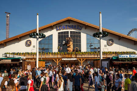 Munich, Germany - September 24, 2016: Facade and entrance of the Loewenbraeu beer tent with people standing in frontのeditorial素材