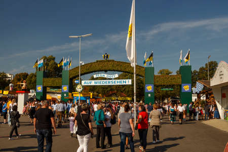 Munich, Germany - September 24, 2016: Exit gate from the Oktoberfest on the Theresienwiese in Munich with unidentified people walking byのeditorial素材