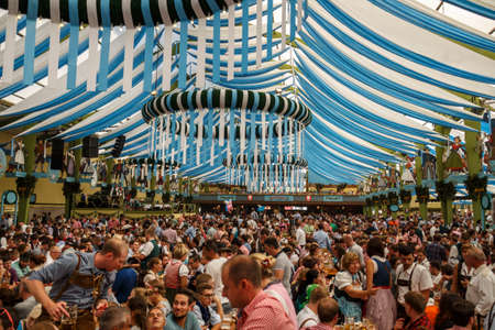 Munich, Germany - September 24, 2016: Inside the Ochsenbraterei beer tent at Oktoberfest with people celebrating and drinking beerのeditorial素材