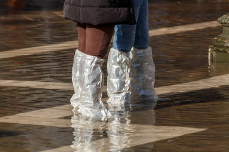 The St. Mark's Square is the principal public square of Venice, sometimes the square is flooded and it is requires to wear protection from the waterの写真素材